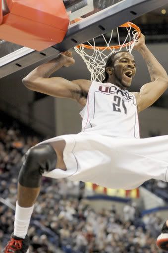 UConn's Stanley Robinson (No. 21) reacts after dunking the ball during the second half of UConn's game against Iona. - Tia Ann Chapman/Hartford Courant