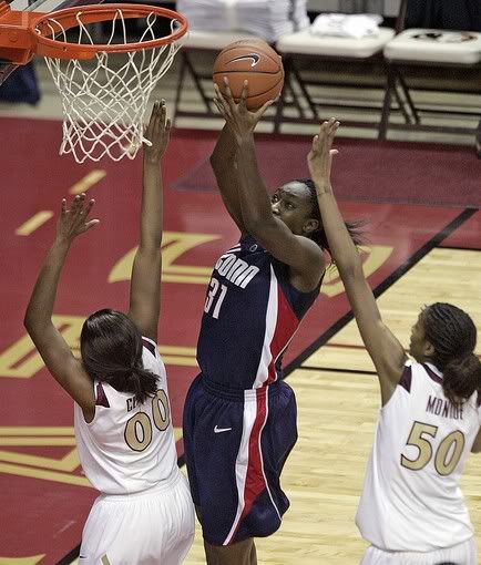 UConn's Tina Charles cuts between Florida State's Chasty Clayton, left, and Jacinta Monroe to score in the second half of the Huskies' 78-59 win on Monday, Dec. 28, 2009, in Tallahassee, Fla - AP Photo