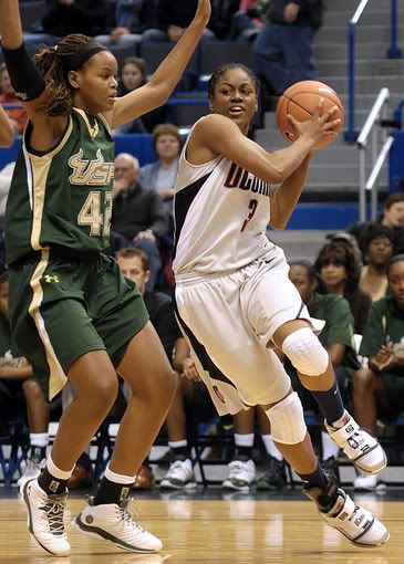 UConn's Tiffany Hayes, right, drives past South Florida's Melissa Dalembert in the first half at the XL Center in Hartford on Monday, Jan. 4, 2010. Hayes was the top scorer for UConn with 22 points - AP Photo