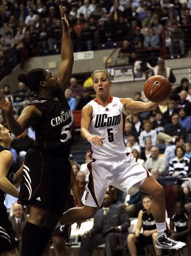 UConn's Caroline Doty (5) passes the ball while being guarded by Cincinnati's Michelle Jones in the first half - AP Photo