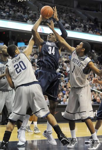 UConn's Alex Oriakhi (34) attempts a tough shot in the lane against Georgetown defenders Hollis Thompson (1) and Jerrelle Benimon (20) during first-half action at the Verizon Center in Washington, D.C., Saturday, January 9, 2010 - Chuck Myers/MCT