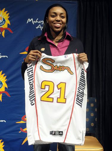 New Connecticut Sun player Renee Montgomery holds up her team jersey after the announcement that the Connecticut Sun has agreed to trade Lindsay Whalen and the No. 2 overall draft choice to the Minnesota Lynx for Montgomery and the No. 1 overall draft pick to the during a press conference in Uncasville, Conn - AP Photo