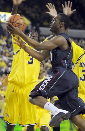 UConn guard Kemba Walker drives to the hoop for a layup as Michigan's Manny Harris defends in the second half. In the end the Walker and the Huskies came up short to the Wolverines - losing 68-63 at Crisler Arena in Ann Arbor, Mich - Patrick Raycraft/Hartford Courantt