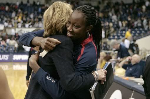 UConn's Tina Charles gets a hug from associate head coach Chris Dailey after UConn beat Pitt 98-56 and Charles surpassed 2,000 career points at the Petersen Events Center in Pittsburgh. Charles finished with 24 points in the game to push her career total to 2,007 - Michael McAndrews/Hartford Courant