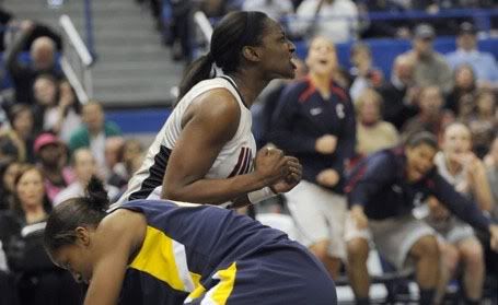 Kalana Greene of UConn reacts after making the basket and drawing the foul on Madina Ali of West Virginia during the second half helping the Huskies to pull away from the Mountaineers. Greene scored 18 points to lead all scorers in a 80-47 victory. The UConn women played West Virginia at the XL Center - John Woike/Hartford Courant