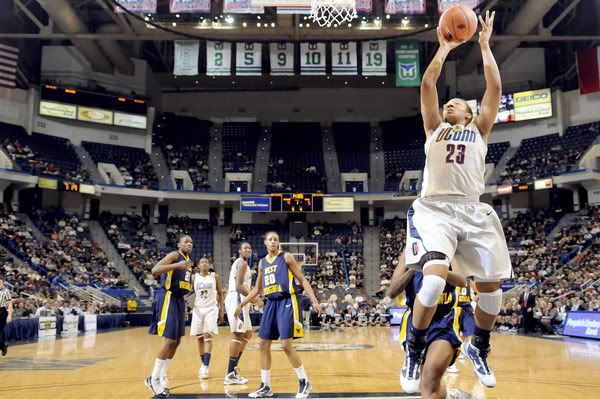 Maya Moore of UConn made it look easy on the quick inlet pass for a flying layup against West Virginia during the first half. Moore had 15 points and grabbed 14 rebounds as the Huskies won 80-47. The UConn women played West Virginia at the XL Center - John Woike/Hartford Courant