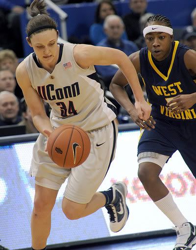 Connecticut's Kelly Faris is pursued by West Virginia's Sarah Miles after Faris stole the ball in the second half of an NCAA college basketball game in Hartford - AP Photo