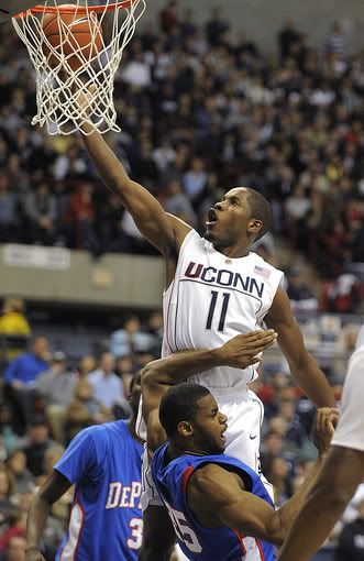 UConn's Jerome Dyson scores two of his team-high 20 points while being guarded by DePaul's Eric Wallace during the second half of the Huskies' 64-57 win at Gampel Pavilion - AP Photo