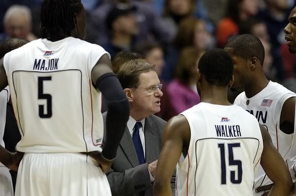 UConn's associate head coach George Blaney, center, who is running the team in Jim Calhoun's absence, speaks to his player during a time-out during the second half of Connecticut's 64-57 win over DePaul at Gampel Pavilion - AP Photo