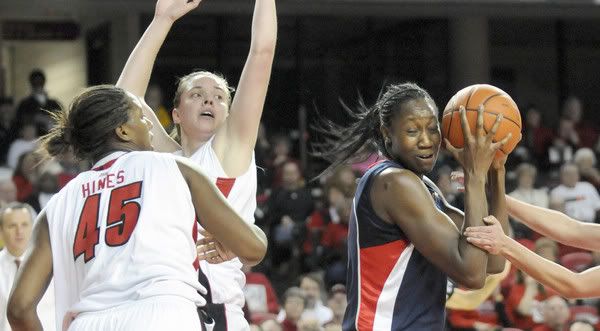 Tina Charles looks for room to shoot around Louisville's Keshia Hines (45) and Brandie Radde,after grabbing an offensive rebound during the first half at Freedom Hall. Charles scored 14 points in the first half - Cloe Poisson/Hartford Courant