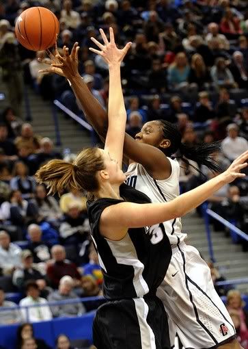 UConn's Tina Charles, right, takes a shot as Providence's Emily Cournoyer, left, guards in the second half at the XL Center in Hartford - Bob Child/AP Photo