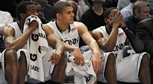 Seniors Stanley Robinson, Gavin Edwards and Jerome Dyson watch the possible end of their UConn careers from the bench against St. John's during the first round of the Big East Tournament. The Huskies lost 73-51 on Tuesday (John Woike/Hartford Courant)
