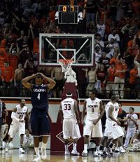 Connecticut's Jamal Coombs-McDaniel (4) walks away as Virginia Tech players celebrate a defensive stop and foul with less than a second left in a second-round NIT college basketball game in Blacksburg, Va. Virginia Tech won 65-63 (AP Photo / The Roanoke Times, Matt Gentry)
