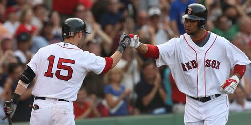BOSTON - AUGUST 22: Alex Gonzalez #13 of the Boston Red Sox celebrates with teammate Dustin Pedroia #15 after hitting a solo home in the second inning against pitcher A.J. Burnett #34 (not pictured) of the New York Yankees at Fenway Park on August 22, 2009 in Boston, Massachusetts. - Getty Images