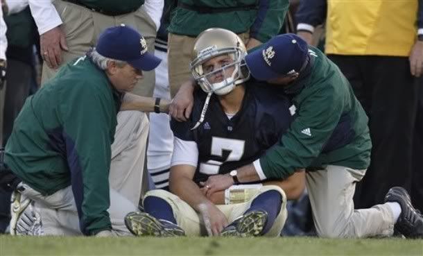 Notre Dame quarterback Jimmy Clausen (7) is looked at by the medical staff after he was hit and fumbled during the third quarter of an NCAA college football game against Navy in South Bend, Ind. , Saturday, Nov. 7, 2009 - AP Photo