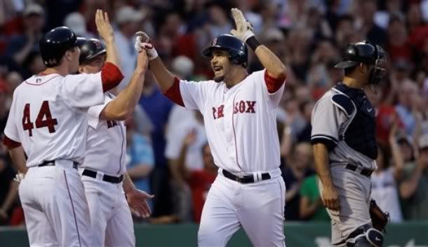 Boston Red Sox Mike Lowell, center, is congratulated by teammates Jason Bay (44) and Kevin Youkilis after his three-run, home run off New York Yankee pitcher Jonathan Albaladejo in the seventh inning of their MLB baseball game at Fenway Park, Saturday, April 25, 2009, in Boston. At right is Yankee catcher Jorge Posada - AP Photo