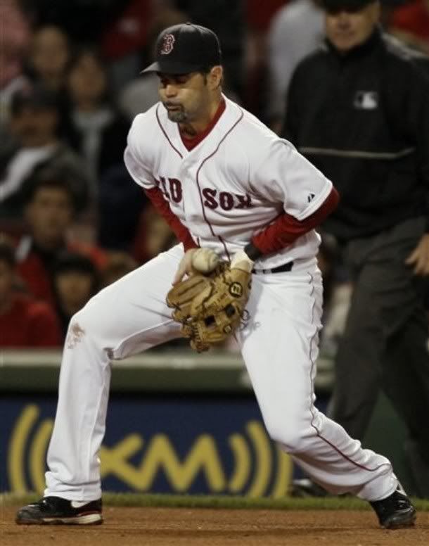 Boston Red Sox third baseman Mike Lowell bobbles a ground ball by Toronto Blue Jays' Aaron Hill, but managed to throw him out, at first during the sixth inning of a baseball game at Fenway Park in Boston, Saturday, Aug. 29, 2009 - AP photo