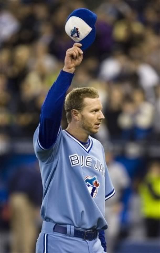 Toronto Blue Jays starting pitcher Roy Halladay tips his cap to the crowd as he leaves the field after throwing a complete game shutout to defeat the Seattle Mariners during AL baseball game action in Toronto, Friday, Sept. 25, 2009 - AP Photo