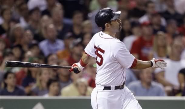 Boston Red Sox's Mike Lowell watches his three-run home run off Chicago White Sox starter Jose Contreras during the third inning of a baseball game at Fenway Park in Boston, Monday, Aug. 24, 2009 - AP Photo