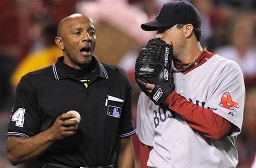 Home plate umpire CB Bucknor and Boston Red Sox starting pitcher Josh Beckett have a discussion between innings during Game 2 of the American League division baseball series Friday, Oct. 9, 2009 in Anaheim, Calif. (AP Photo/Chris Carlson)