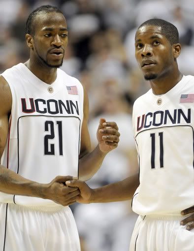 Stanley Robinson and Jerome Dyson of UConn breathe a sigh of relief as the Huskies held off stubborn Hofstra for a 76-67 victory on Tuesday at Gampel Pavilion. Dyson led the Huskies with 23 points, including nine in a row late, and Robinson added 15 - John Woike/Hartford Courant