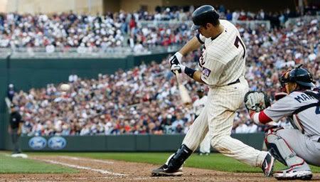 Minnesota Twins' Joe Mauer hits a double against Boston Red Sox pitcher Scott Atchinson during the eighth inning of the Twins' home opener baseball game at their new stadium, Target Field, in Minneapolis, Monday, April 12, 2010. The Twins beat the Red Sox 5-2. (AP Photo/Ann Heisenfelt)