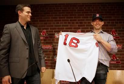 Boston Red Sox general manager Theo Epstein, left, looks on as newly signed Red Sox shortstop Marco Scutaro(notes) displays a Red Sox uniform during a news conference at Fenway Park, in Boston, Friday, Dec. 4, 2009. After cycling through seven shortstops since the middle of the 2004 season, the Red Sox announced on Friday that they have given Scutaro a two-year deal with a club option for 2012 - AP Photo