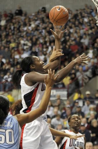 UConn's Tina Charles shoots for two of her 25 first-half points against the University of North Carolina at Gampel Pavilion. Charles scored one more point than UNC scored in total in the first half. UConn was in total control, leading at the half, 56-24 - Cloe Poisson/Hartford Courant