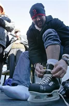 Boston Red Sox catcher Jason Varitek(notes) laces up a pair of ice skates before participating in the First Skate at Fenway, Friday, Dec. 18, 2009, in Boston. The Boston Bruins and Philadelphia Flyers will face off in the Winter Classic NHL hockey game on Jan. 1, 2010 - AP Photo