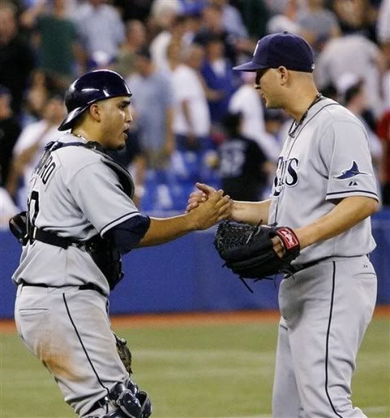 Tampa Bay Ray's catcher Dioner Navarro, left, congratulates pitcher Joe Nelson on getting the final out following the 12th inning as the Rays beat the Toronto Blue Jays 10-9 in a baseball game in Toronto on Saturday, July 25, 2009 - AP Photo