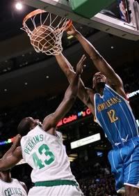 Former UConn Husky and New Orleans Hornets center Hilton Armstrong (12) dunks the ball over Boston Celtics' Kendrick Perkins (43) - AP Photo