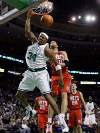 Boston Celtics forward Paul Pierce (34) dunks past New Jersey Nets center Brook Lopez (11) as Nets forwards Bobby Simmons (21) and Ryan Anderson (20) watch along with Celtics' Kevin Garnett (5) during the first quarter - AP Photo