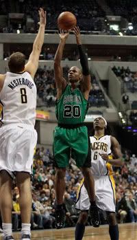 Boston Celtics guard Ray Allen, center, shoots over Indiana Pacers center Rasho Nesterovic, left, of Slovenia, in the first half of an NBA basketball game - AP Photo