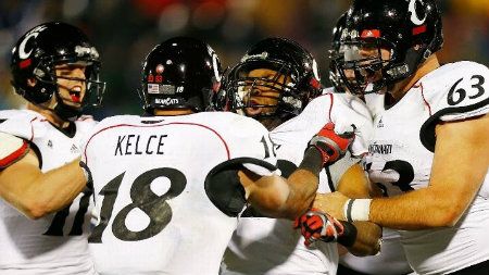 George Winn #32 of the Cincinnati Bearcats celebrates with teammates Travis Kelce #18 and Dan Sprague #63 of the Cincinnati Bearcats after scoring a touchdown in the second half against the Connecticut Huskies during the game at Rentschler Field on December 1, 2012 in East Hartford, Connecticut. (