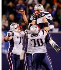 The offensive line lifts Brady after the record breaker -AP Photo