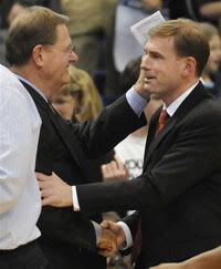 Connecticut associate head coach George Blaney, left, shakes hands son, Fairfield University assistant coach Brian Blaney, right, at the end of an NCAA college men's basketball game in Hartford, CT - AP Photo