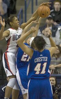 Maya Moore blocks a shot by Sam Quigley of DePaul during the first half. Moore also scored 18 points to go with 12 rebounds, 11 defensive, and 3 steals - Hartford Courant Photo