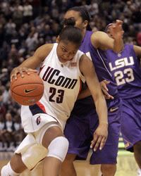 UConn's Maya Moore drives for the basket as LSU's Katherine Graham defends during the first half - AP Photo