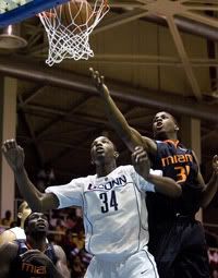 UConn center Hasheem Thabeet, left, watches his shot go in as Miami's DeQuan Jones covers him during Sunday's second-round game in the Paradise Jam basketball tournament