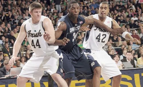 Notre Dame forward Luke Harangody, left and Ryan Ayres, right, attempt to keep Connecticut center Hasheem Thabeet out of the lane during the first half of UConn's 69 - 61 win over Notre Dame - Joe Raymond/AP Photo
