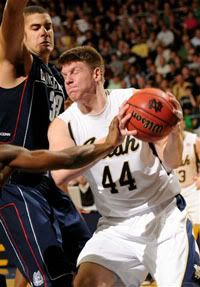 Notre Dame forward Luke Harangody, right, drives the lane as Connecticut forward Gavin Edwards defends during the first half of an NCAA college basketball game Saturday Jan. 24, 2009 in South Bend, Ind. (AP Photo/Joe Raymond)