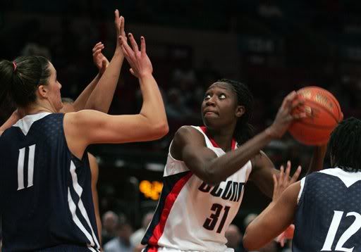 Connecticut's Tina Charles (31) looks to shoot past Penn State's Julia Trogele (11) during the second half of the Maggie Dixon Classic NCAA college basketball game at Madison Square Garden in New York - AP Photo