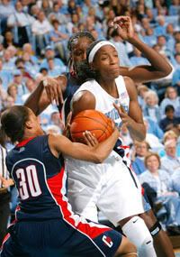 Lorin Dixon (30) and Tina Charles (31) of UConn trap North Carolina's Rashanda McCants during Monday's No. 1 vs. No. 2 clash at the Dean E. Smith Center in Chapel Hill, N.C - KEVIN C. COX / GETTY IMAGES