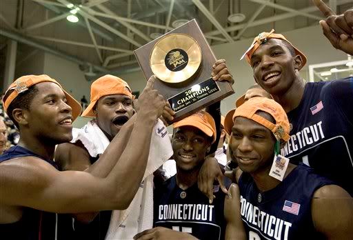 Connecticut teammates celebrate with their trophy after winning the 2008 Paradise Jam basketball tournament championship game against Wisconsin - AP Photo