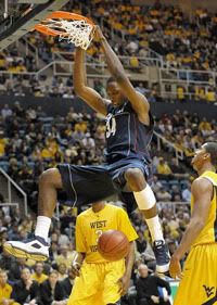 UConn's Hasheem Thabeet dunks between West Virginia forwards Devin Ebanks (3) and Wellington Smith during the first half - AP Photo