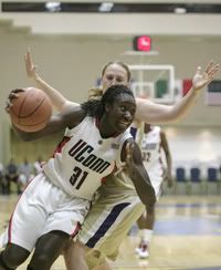 UConn's Tina Charles, left, battles with Washington's Laura Mclellan during a match of the Women's College Basketball Caribbean Classic tournament in Cancun, Mexico. - AP Photo