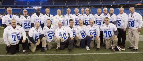Members of the 1958 University at Buffalo Bulls, including Willie Evans, one of two black players on the team which voted against going to the Tangerine Bowl because of local segregation rules in Orlando, Florida, pose for a photo at the Rogers Centre in Toronto. The team was presented with football jerseys commemorating the anniversary of the International Bowl. - AP Photo