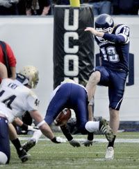 UConn kicker Desi Cullen has his punt blocked by Pitt's Mike Toerper early in the game. - Hartford Courant Photo