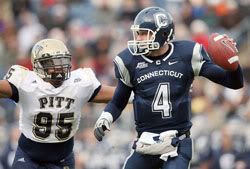 UConn's Tyler Lorenzen scrambles as he is chased by Mick Williams of the Pittsburgh Panthers.  - Getty Images
