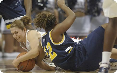 Mel Thomas diving for a loose ball - Courant Photo